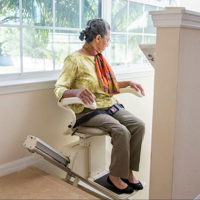 Lady riding Straight Indoor Stairlift